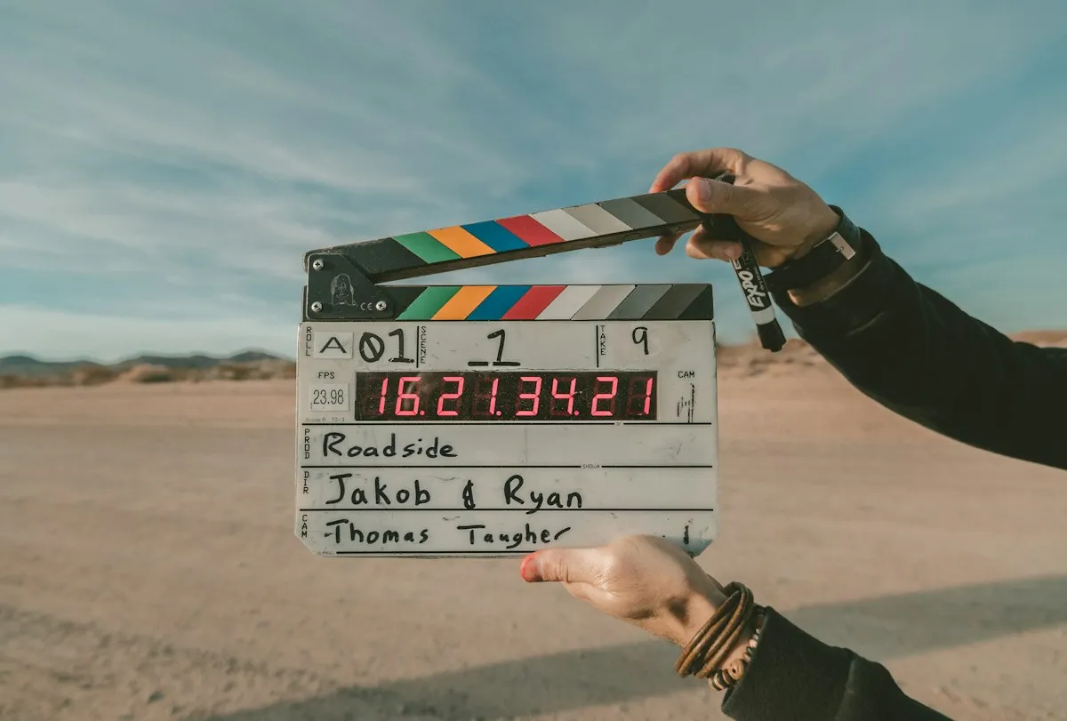 Temporary editorial photograph of a production clapperboard; founder portrait to come